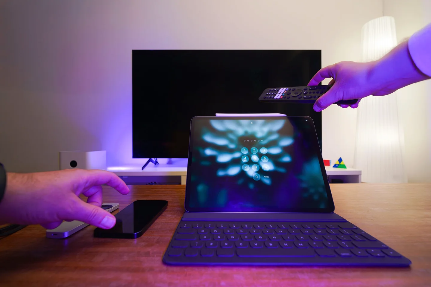 Real home entertainment setup with television, laptop, tablet and remote