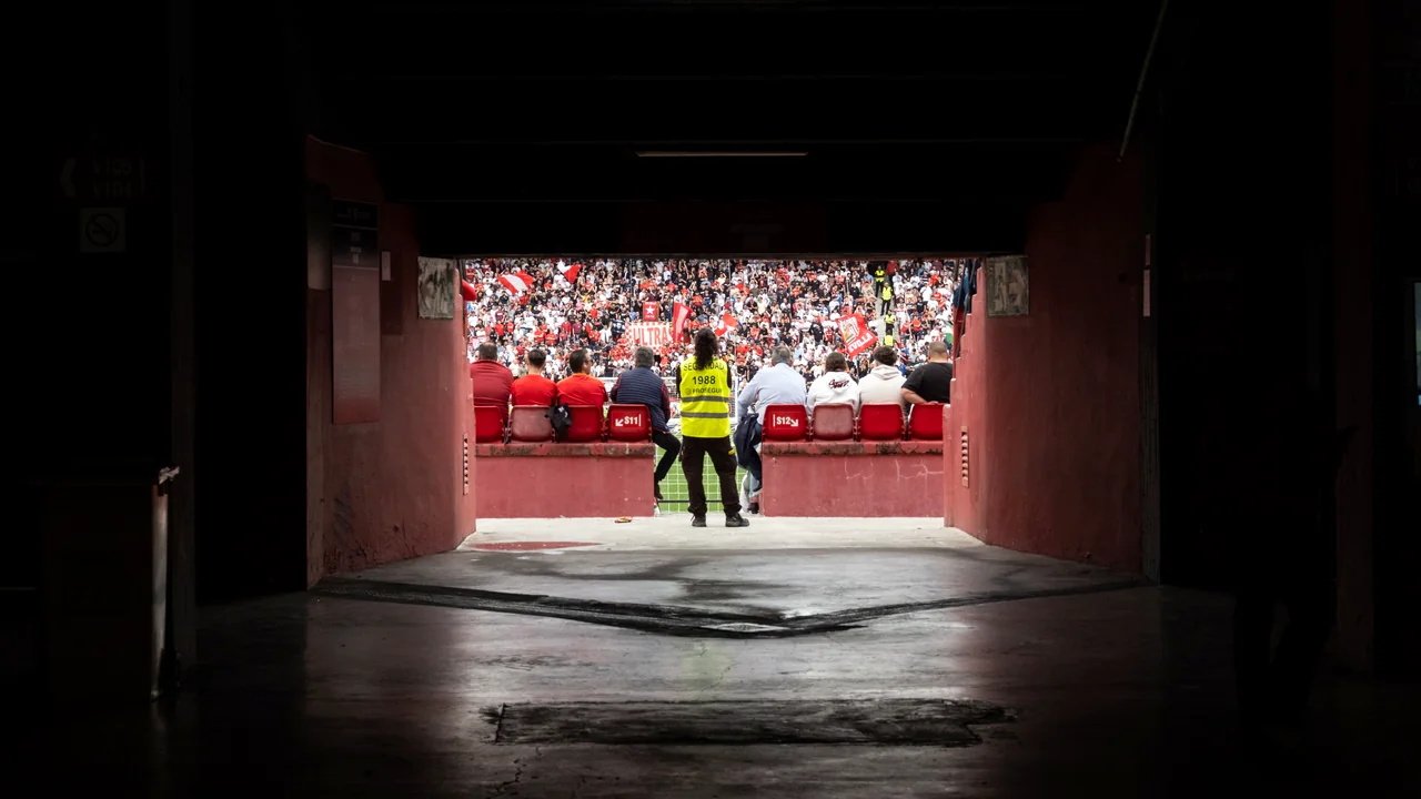 Stadium tunnel opening onto a packed stand before kick-off